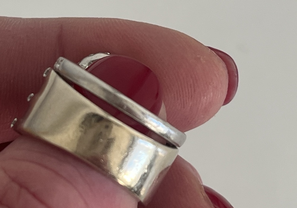 Close view of Jennifer's platinum engagement ring and 18ct white gold dress ring after years of wear