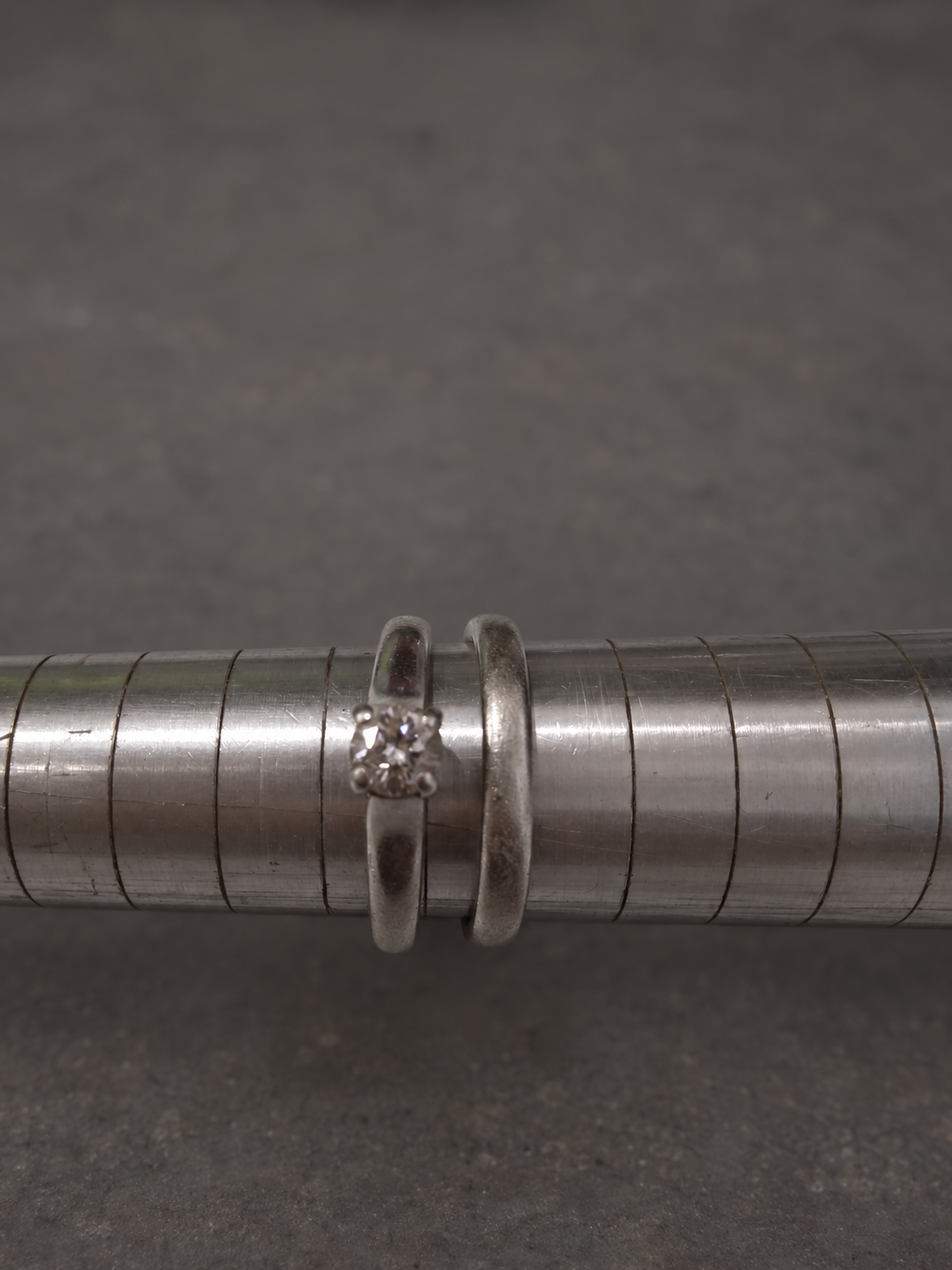 Platinum rings before professional polishing, showing a softer worn finish.