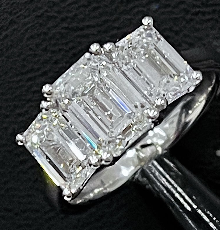 Lab-grown emerald cut diamond trilogy engagement ring in platinum