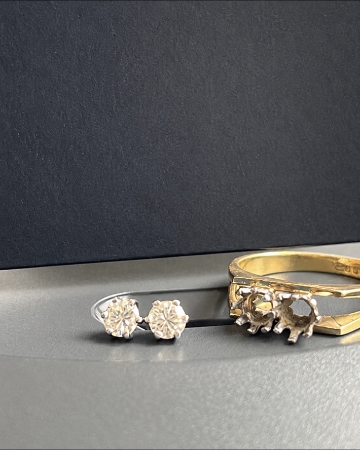 Two existing diamonds remounted as platinum six claw stud earrings