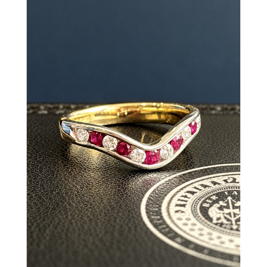 Finished curved ruby and diamond half eternity ring