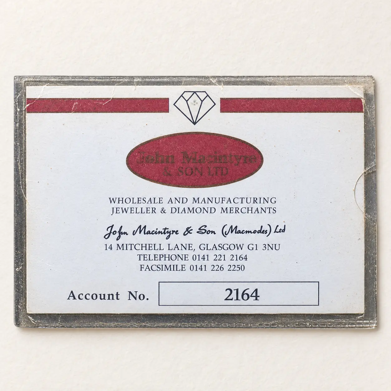 Vintage blue and red John Macintyre and Son account card.