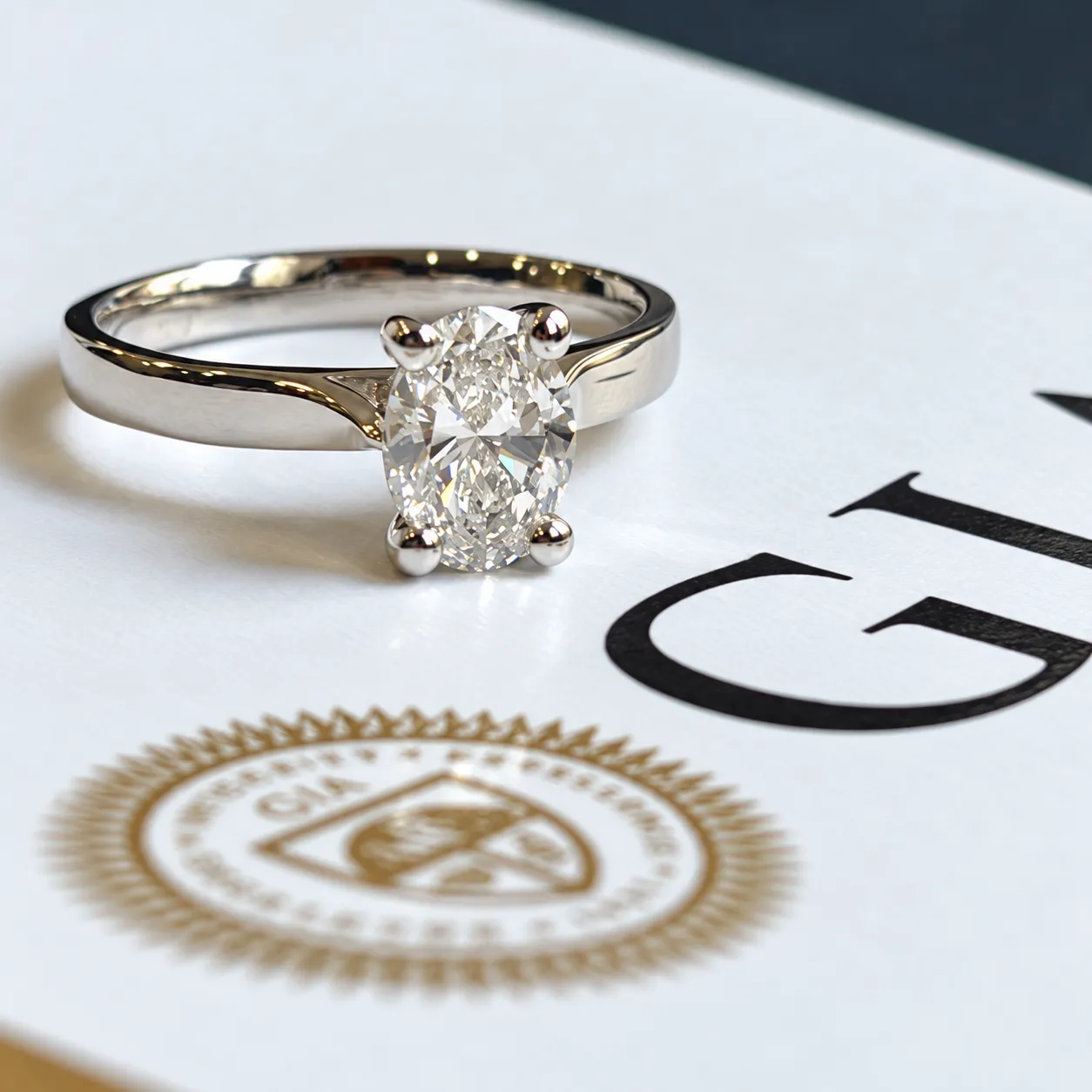 Completed platinum solitaire ring set with an oval cut diamond.