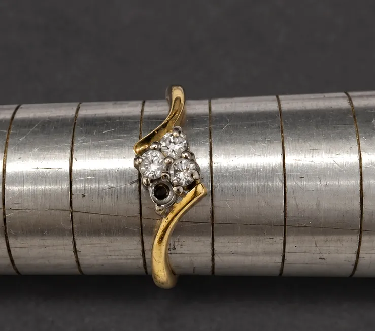 Ring before workshop work; a diamond is missing.